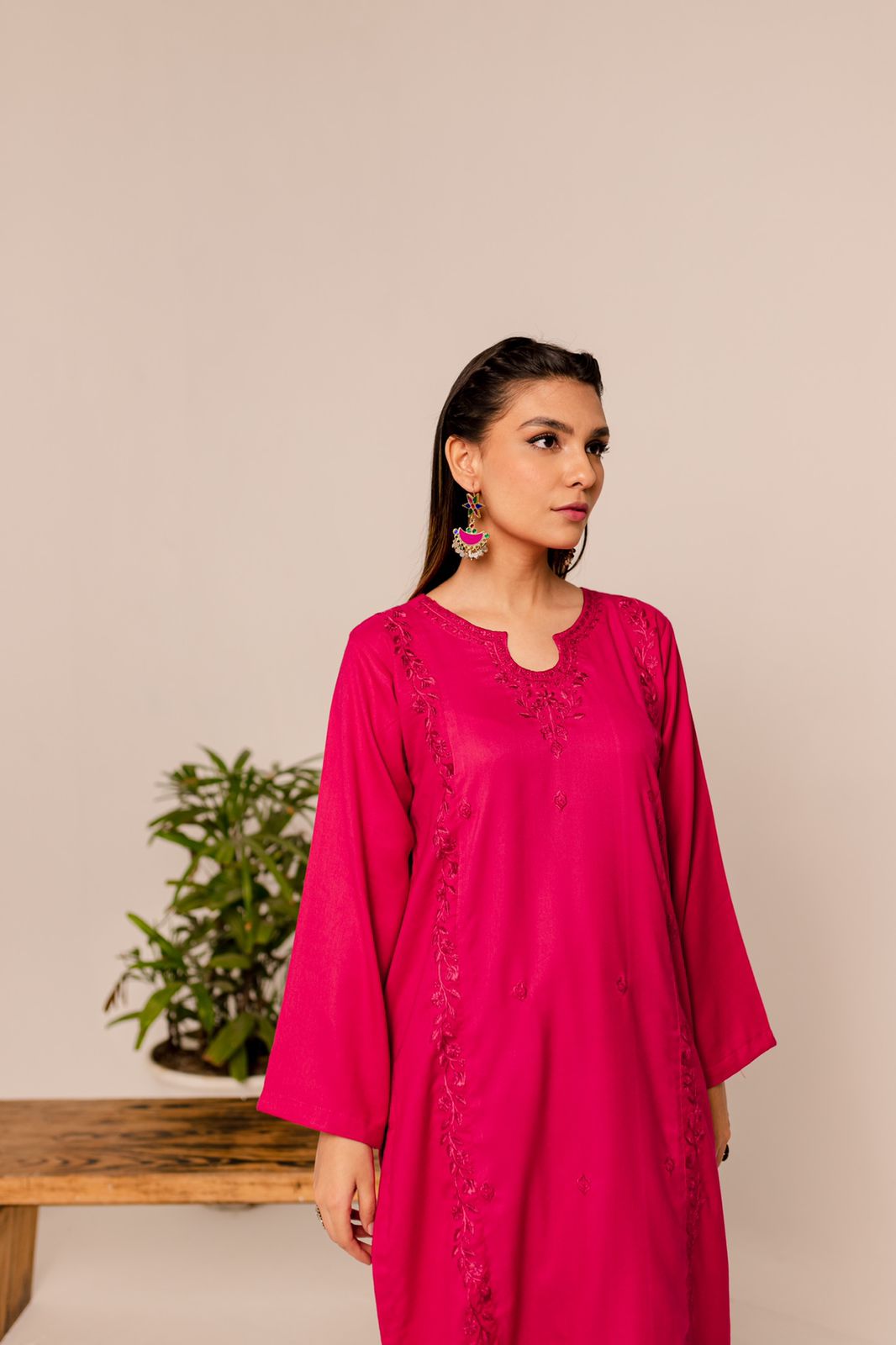 model wearing 2 piece shocking pink embroidered dress